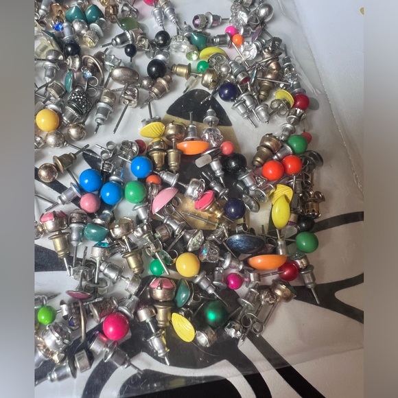 Bag full of different colored stud earrings. - Picture 4 of 13